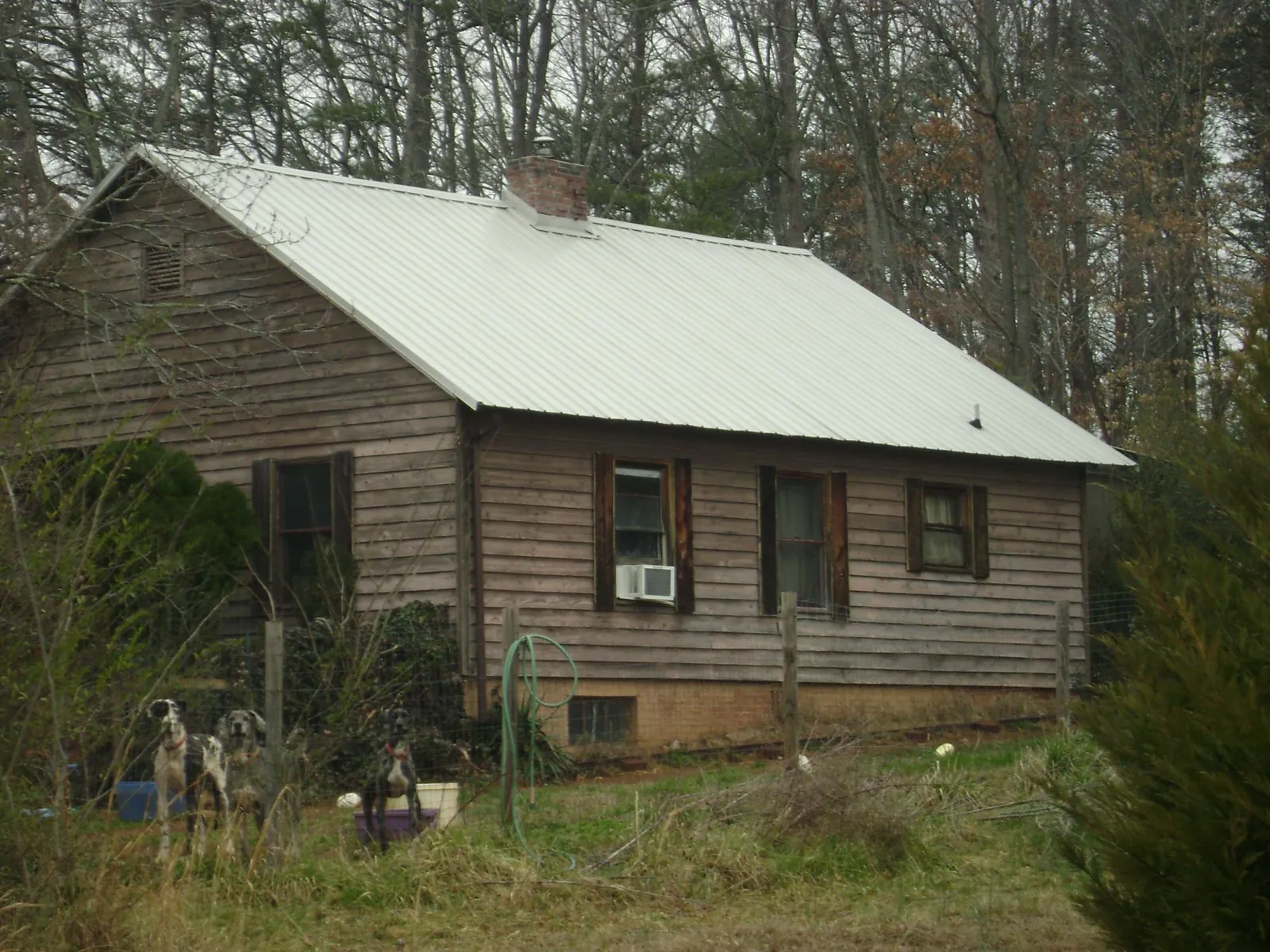 White metal roof on an old wood sided farmhouse, from a Metal Roof Installation job in Glen Cove
